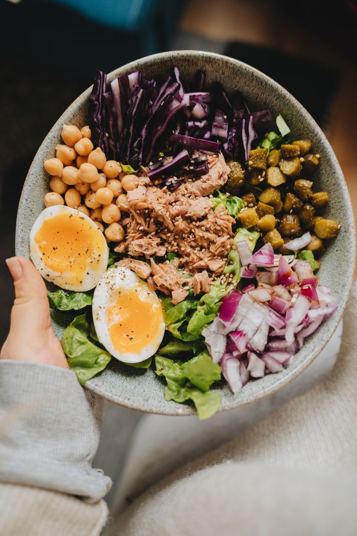 Bowl with tuna, boiled eggs, chickpeas, and vegetables
