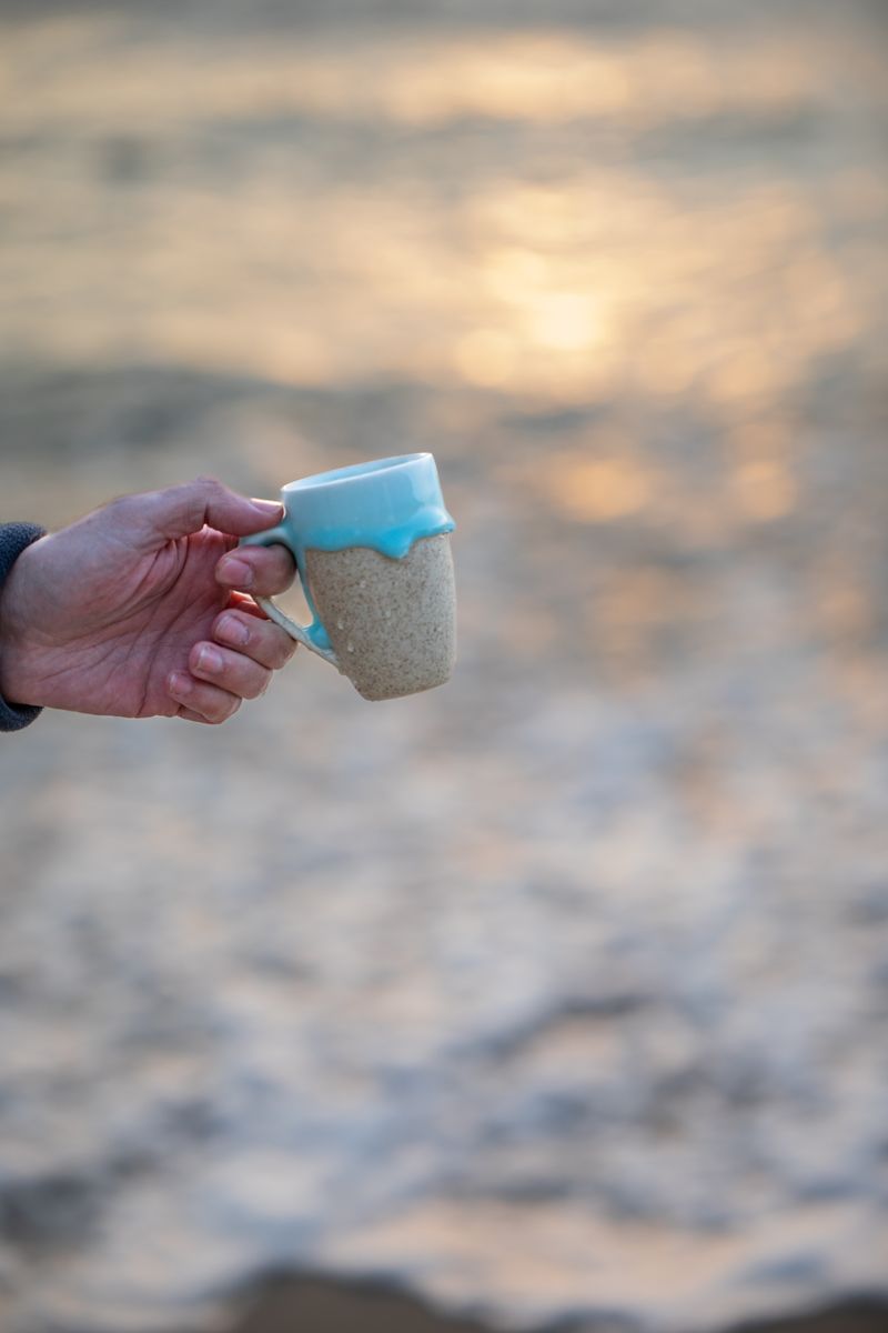 Morning coffee at sunrise by the water